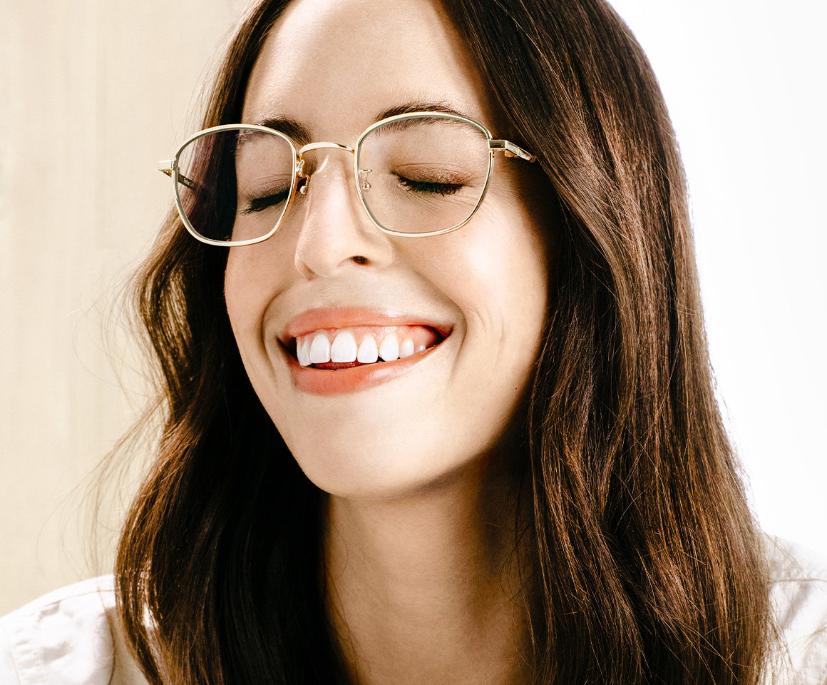 Woman laughing while wearing felix gray glasses