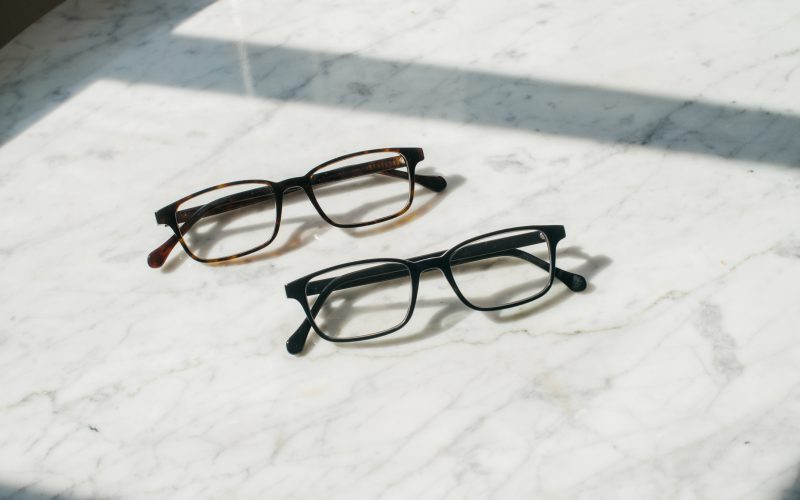 Two Felix Gray Blue Light Glasses on a marble table