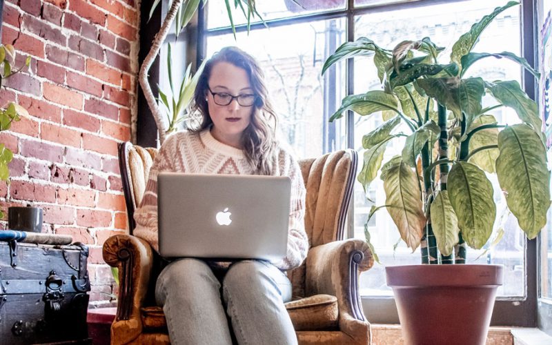 Woman working on her laptop in a coffee shop