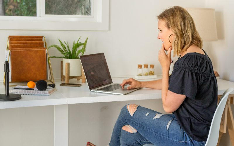 Woman working from a home office looking at her computer